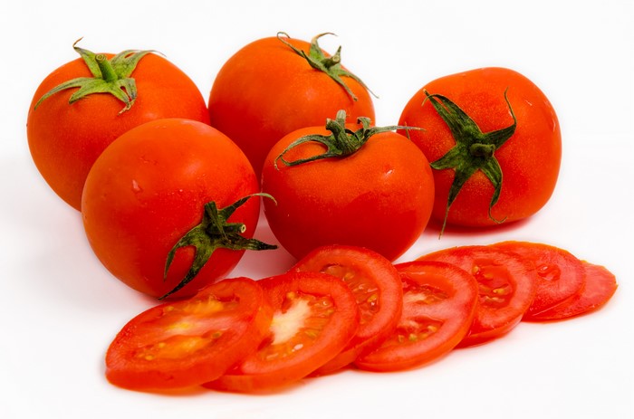Tomatoes and Sliced Tomatoes on White Background