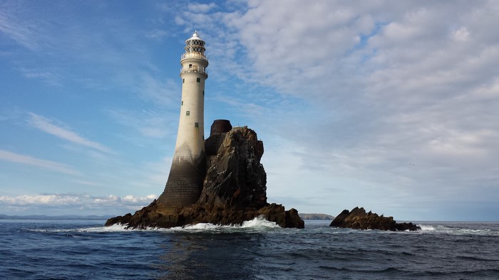 Fastnet Rock Lighthouse on a rocky island in the sea