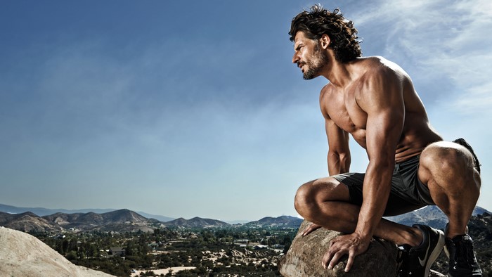 Joe Manganiello Crouching on a Rock