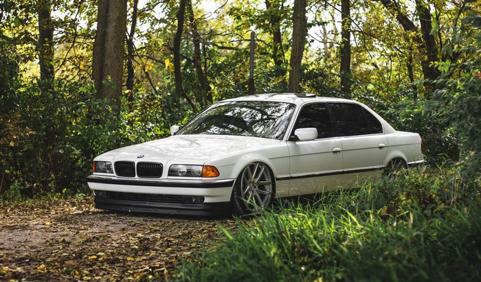 White BMW 7 Series E38 in Forest
