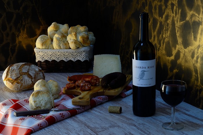 Still-life with wine, bread, sausage, and cheese