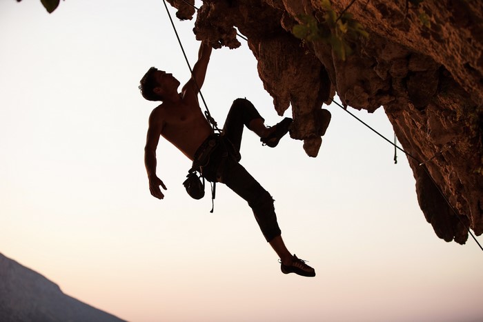 Man rock climbing on a cliff face