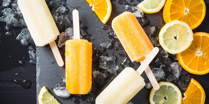 Orange and Lemon Popsicles with Ice and Fruit Slices