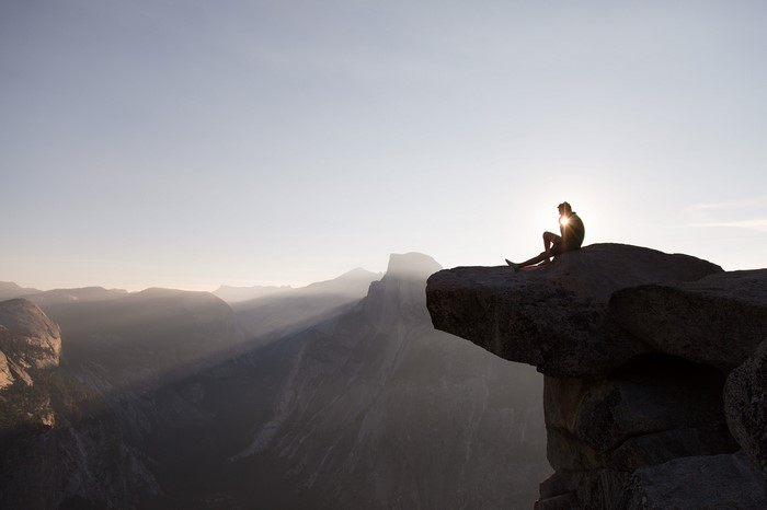 Man sitting on cliff edge at Yosemite National Park