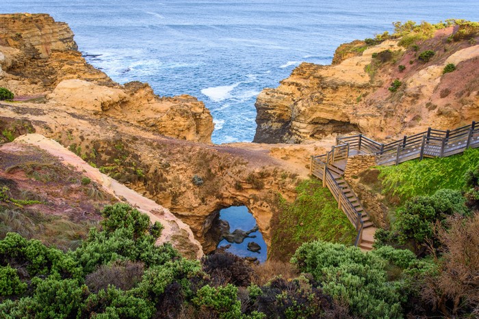 Archway Rock Formations and Wooden Stairs by the Sea