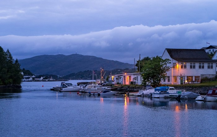 Boats docked in a Norwegian bay at dusk