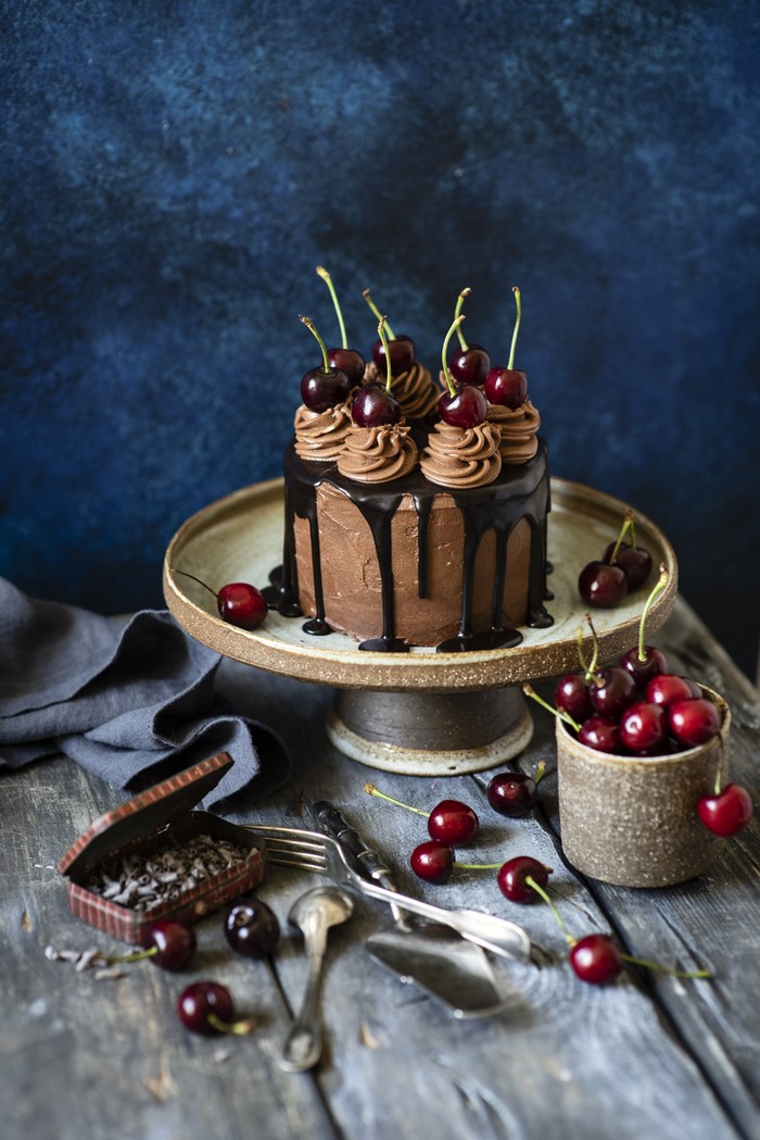 Chocolate cake with cherries on a cake stand