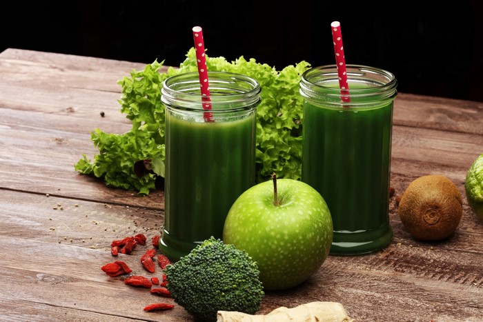 Green Smoothies with Fruits and Vegetables on Wood