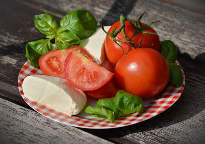 Caprese Salad with Mozzarella, Tomatoes, and Basil on Plate
