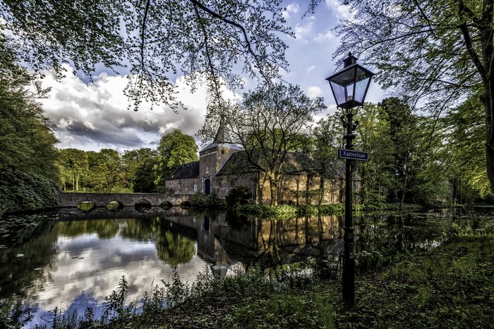 Arcen Castle in Limburg, Netherlands with a bridge and street light