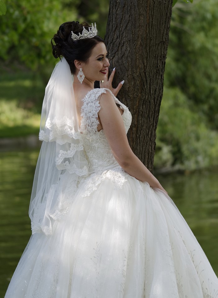 Bride with Crown and Veil Posing by Tree
