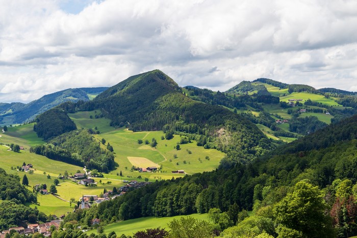 Green rolling hills and forests in Waldenburg County, Switzerland