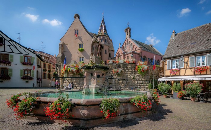 Fountain and historic buildings in Eguisheim, France
