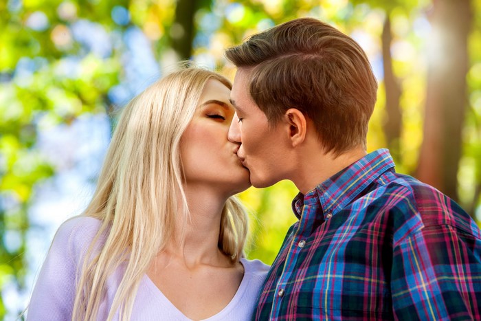 Couple kissing outdoors