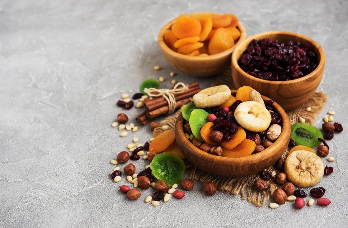 Bowls of dried fruits and nuts with cinnamon sticks