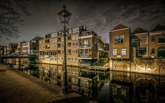 Canal in Gorinchem, Netherlands at dusk with street lights
