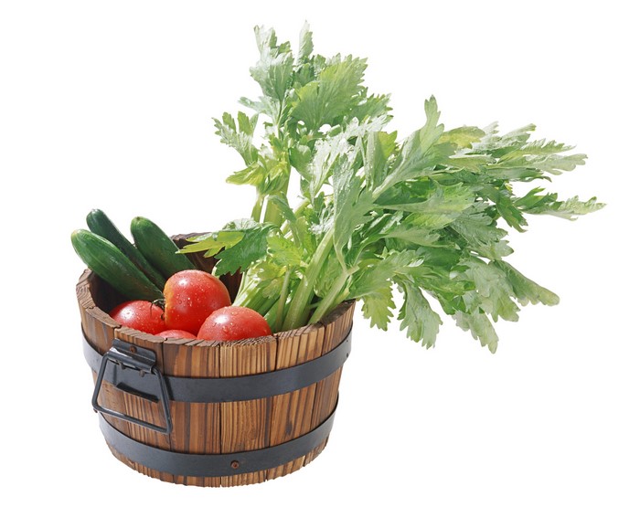 Wooden bucket filled with fresh vegetables
