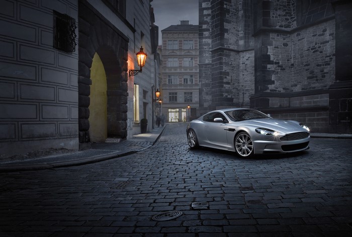 Silver Aston Martin DBS on cobblestone street