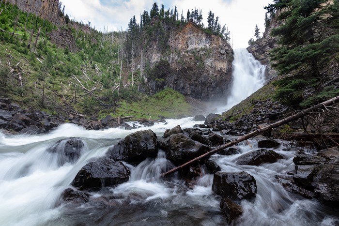 Waterfall in a rocky canyon with trees