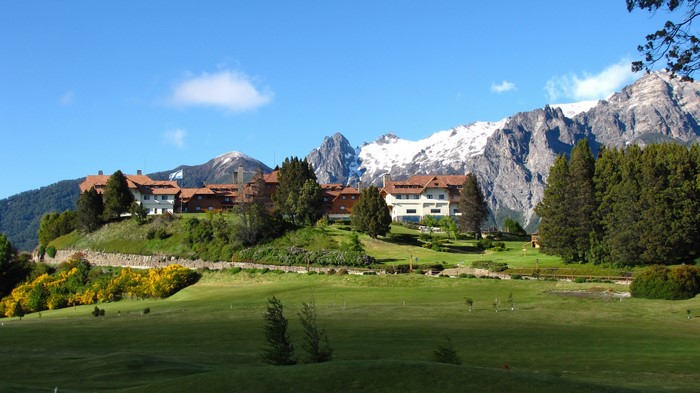 Hotel on a hill with snow-capped mountains in Bariloche, Patagonia