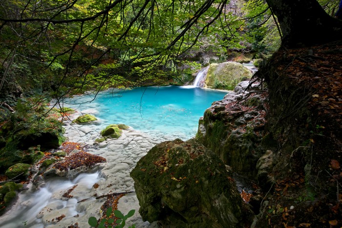 Turquoise Stream with Mossy Rocks in Navarra, Spain
