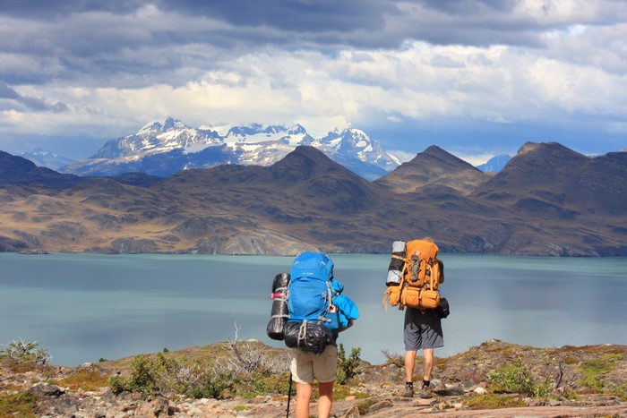 Two hikers with backpacks in Torres Del Paine National Park, Chile