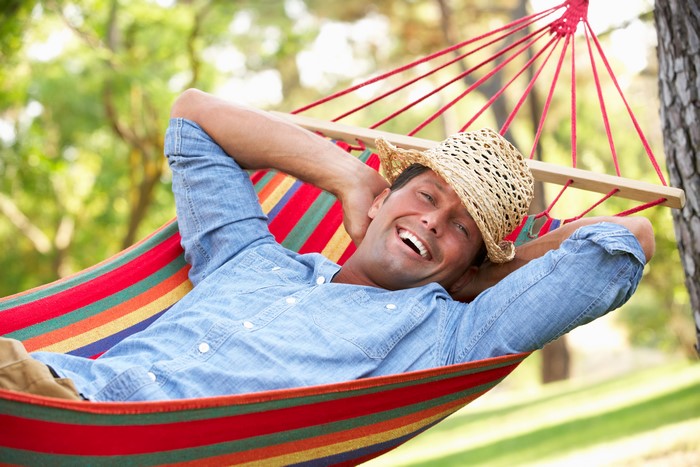 Man in Straw Hat Relaxing in Hammock