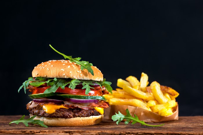 Hamburger and French Fries on a Wooden Table