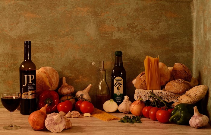 Still life with bread, wine, vegetables, and pasta