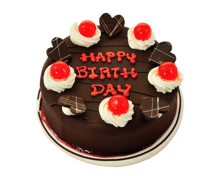 Chocolate birthday cake with cherries and hearts