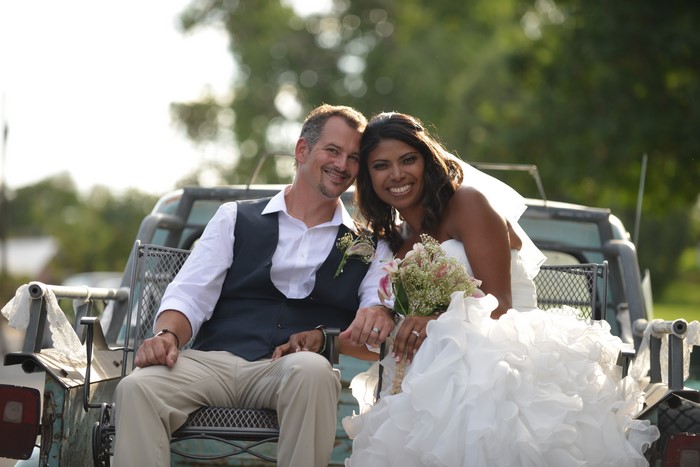 Bride and Groom sitting in a wagon