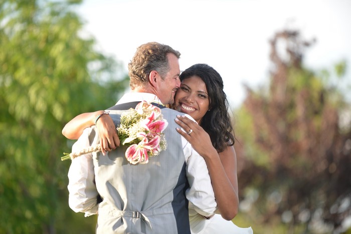 Bride and Groom Hugging with Bouquet