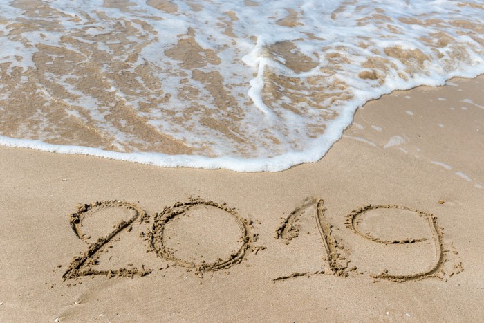 2019 written in sand with waves