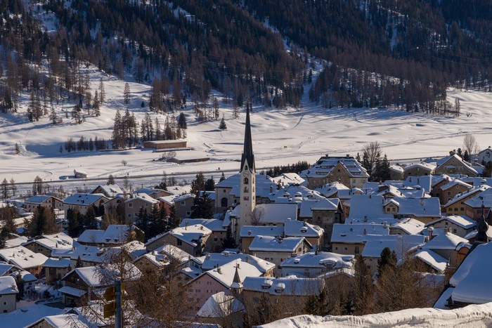 Snowy Swiss Village with Church and Forest
