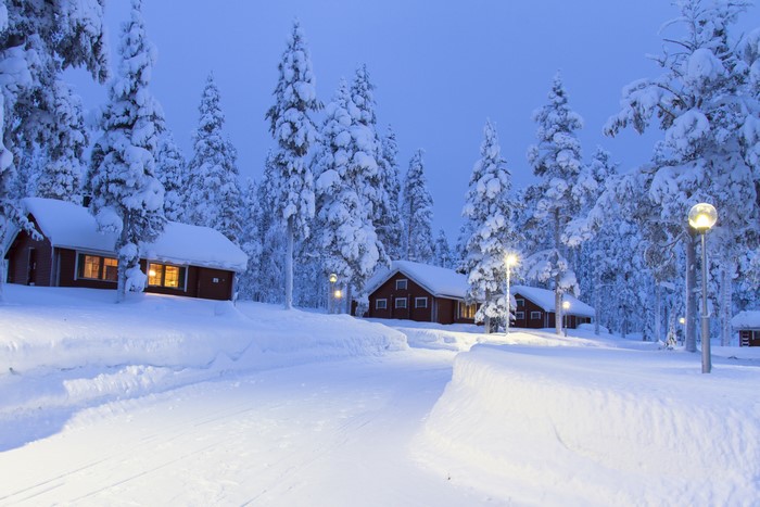 Snowy cabins in Lapland, Finland with street lights