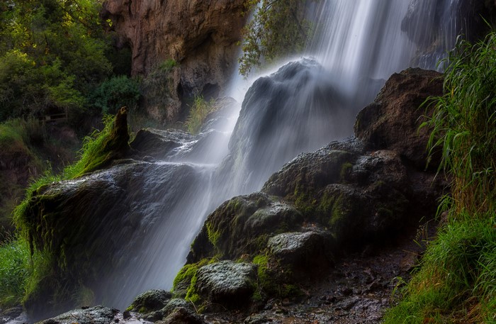 Waterfall cascading over mossy rocks in Rifle Falls State Park