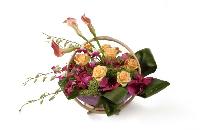 Ikebana arrangement with roses, callas, and orchids