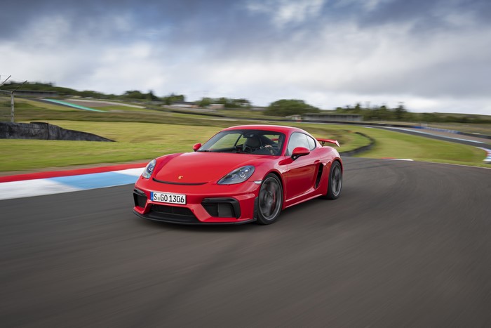 Red Porsche 718 Cayman GT4 on a Racetrack