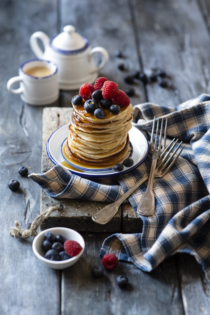 Stack of pancakes with berries and coffee