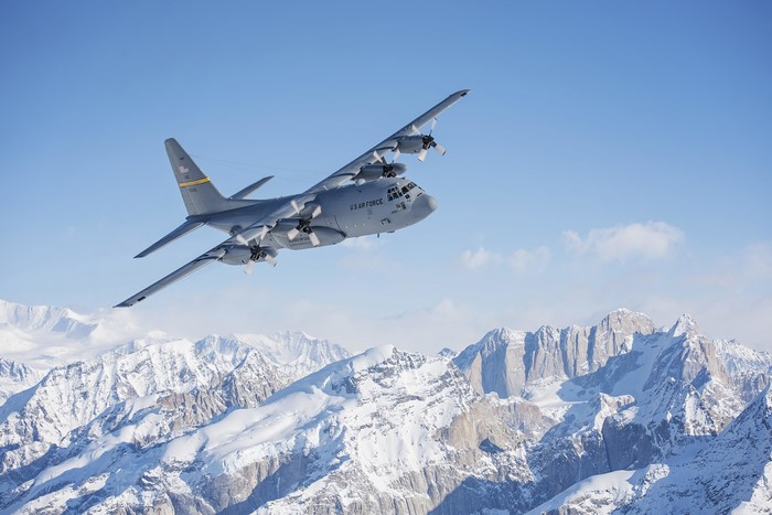 C-130 Hercules flying over snowy mountains