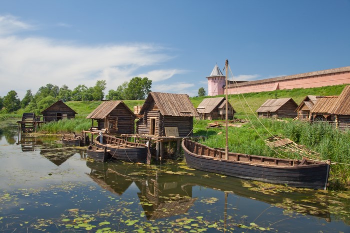 Wooden houses and boats on the river in Suzdal