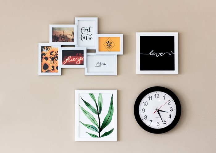 Wall collage with pictures and a clock
