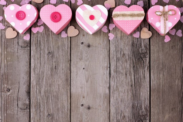 Valentine's Day heart gift boxes on wood planks