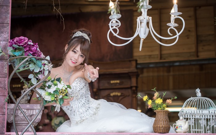 Bride in a sparkling dress holding bouquets