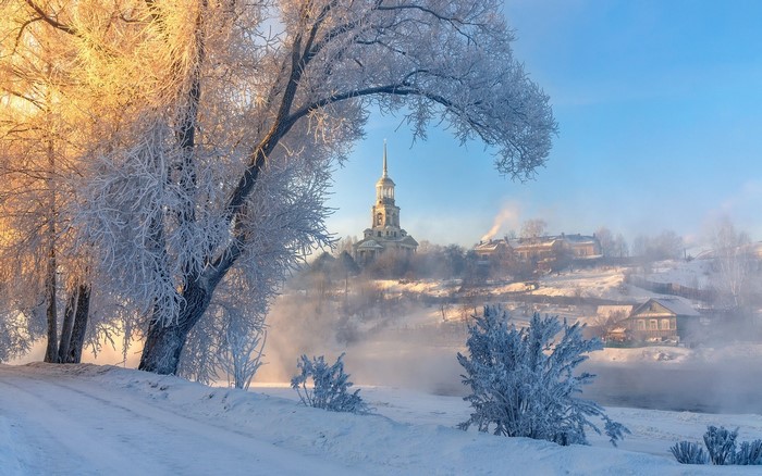 Winter scene with church and houses in Torzhok, Tver region, Russia