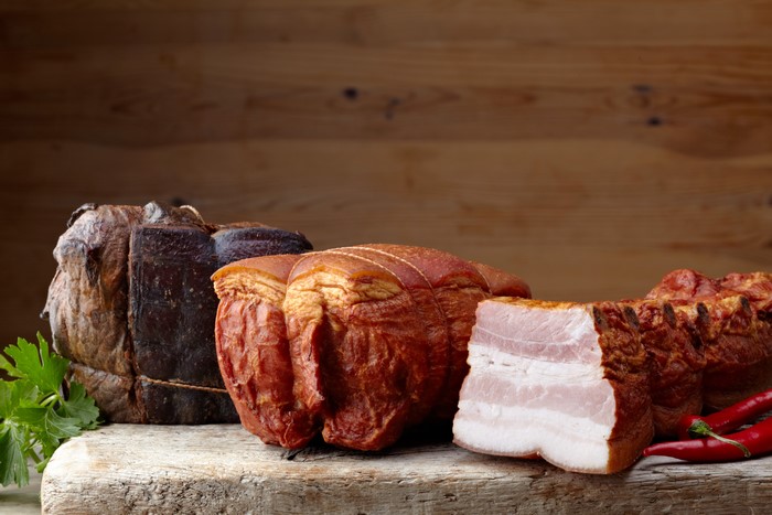 Smoked Meat Products and Chili Peppers on Wood