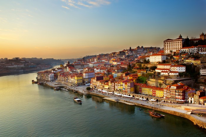 Porto, Portugal riverfront at sunset with colorful buildings