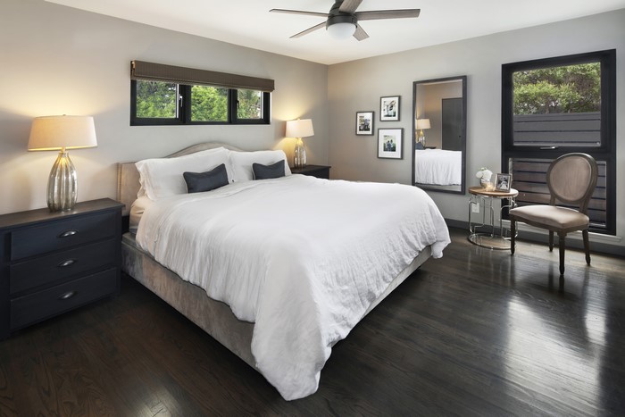Bedroom with bed, lamps, and chair