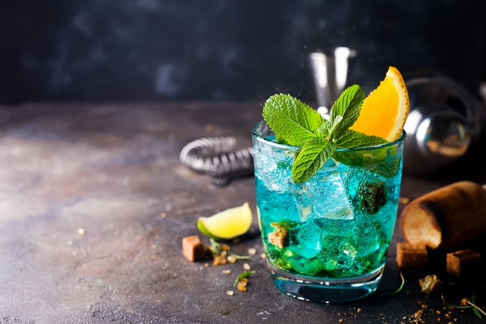 Blue cocktail with mint and orange slice