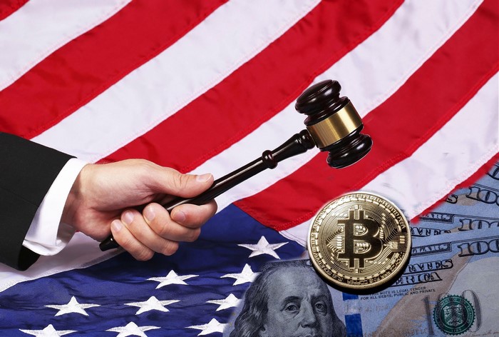 Gavel and Bitcoin on USA Flag and Dollar Bills